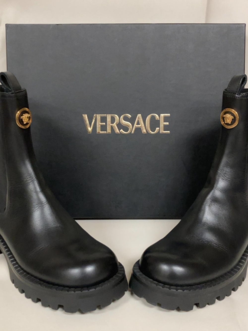 Versace Black Leather Lug-Sole Chelsea Boots with Gold Medusa Medallions